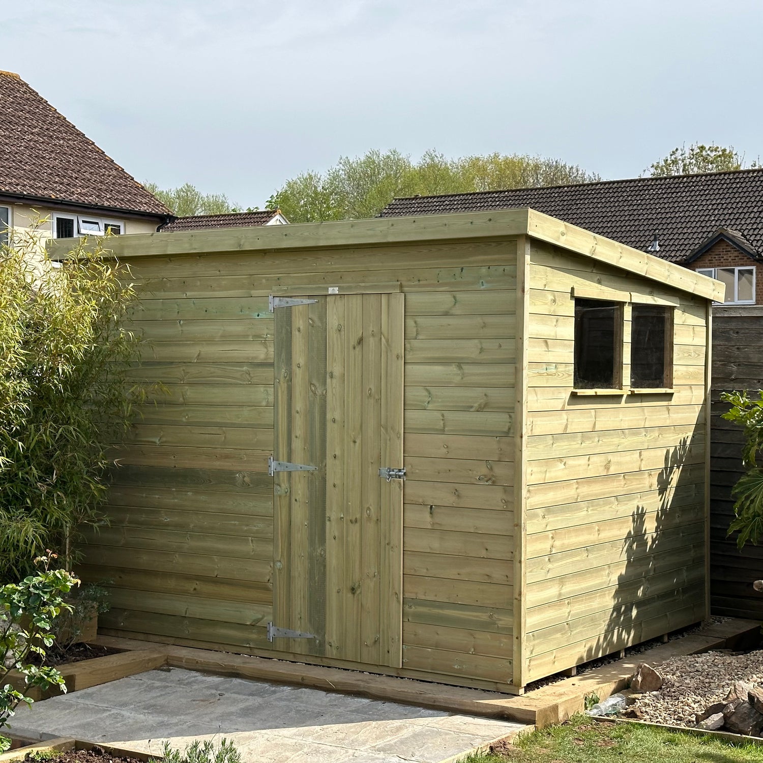 6x10 standard pent shed with 2 windows and a single door on the front.